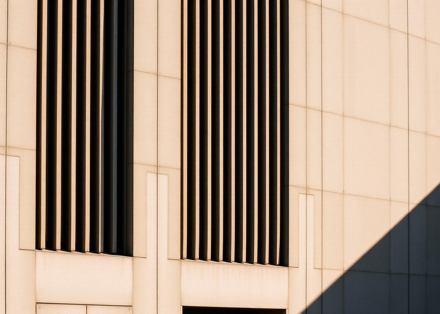 Architectural concrete facade with ventilation louvres in raking light